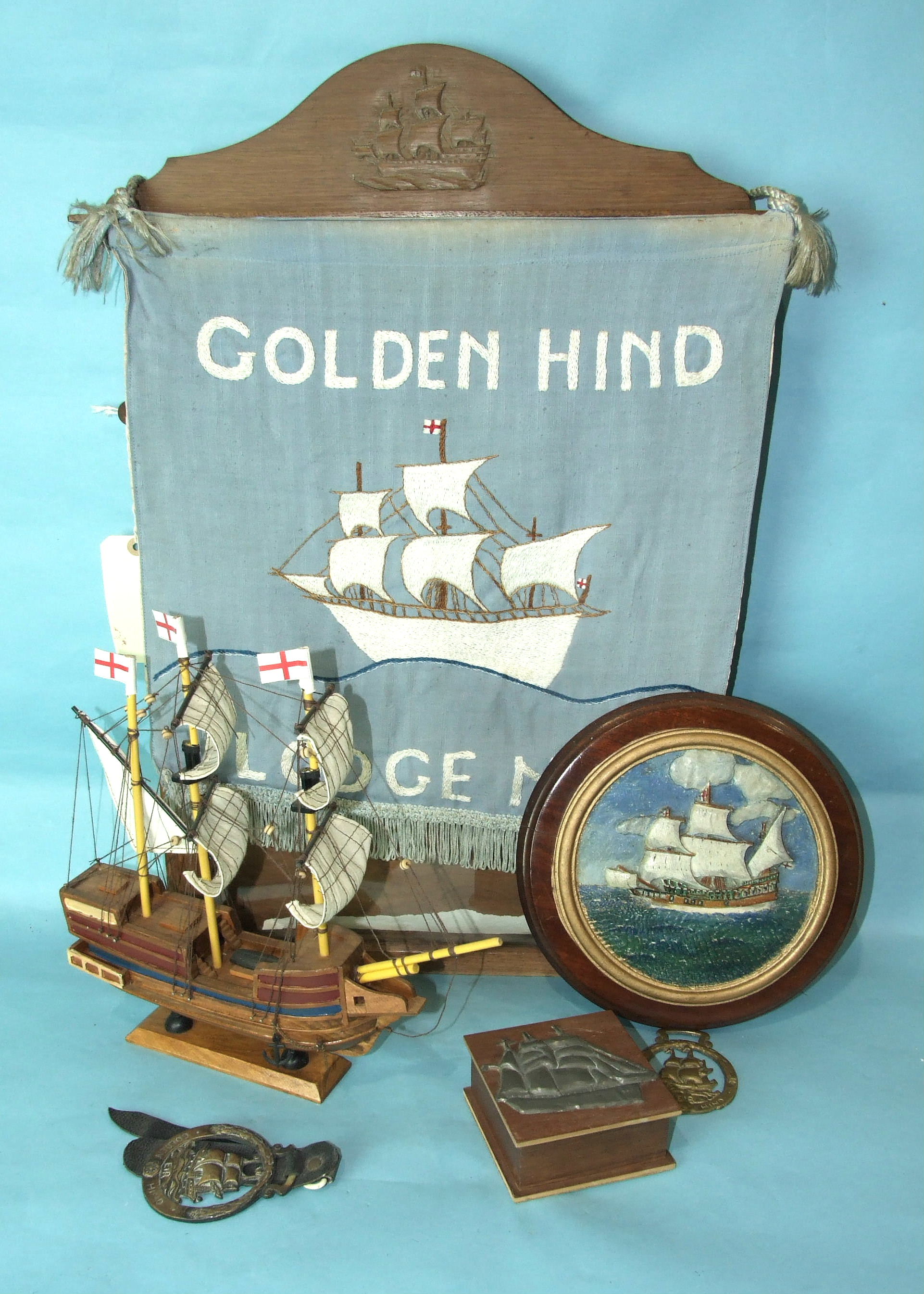 An oak-glazed certificate case, 65 x 40cm, a small carved wood model of the Golden Hind, a Golden