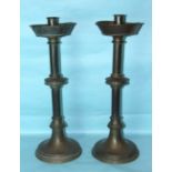 A pair of bronze and copper ecclesiastical candlesticks, 67cm high, (2).