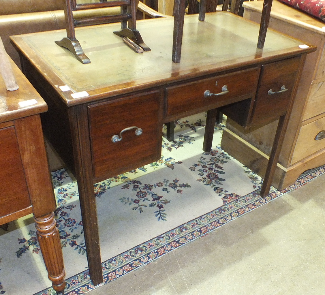 A stained wood finish writing table, the rectangular top with inset above three drawers, on square