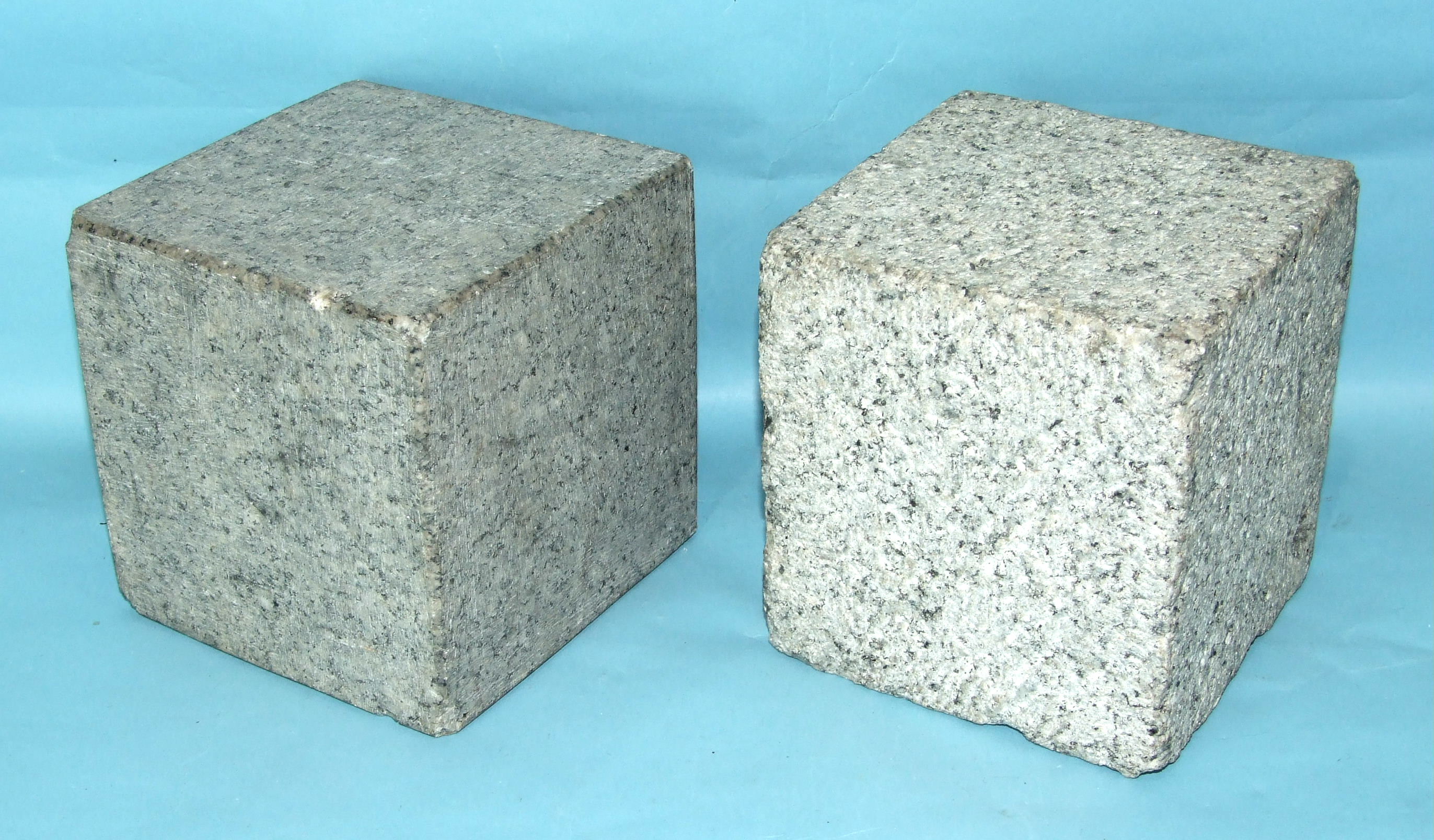 A large pair of cube-shaped granite ashlars, 15cm, (2).