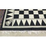 An HRA black and white chequered carpet, 256 x 365cm.