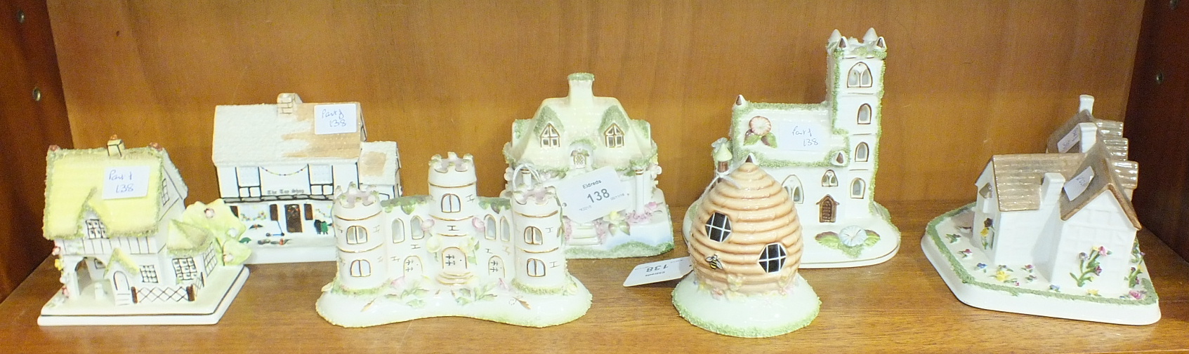 A collection of seven Coalport bone china cottage models, including: 'The Master's House', 'The