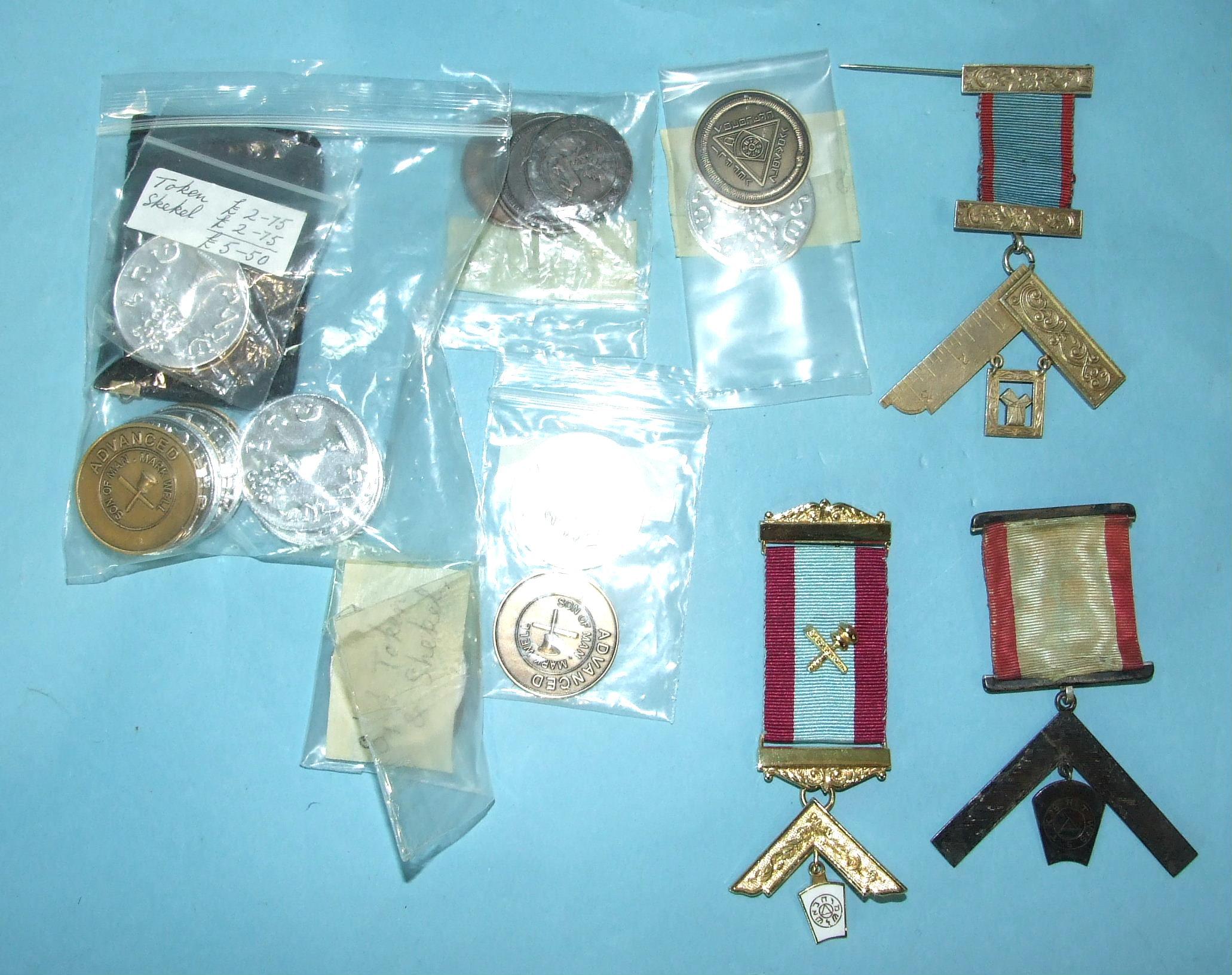 A collection of Mark Masonic tokens, an old Past Master's jewel, a new Past Master's jewel and a