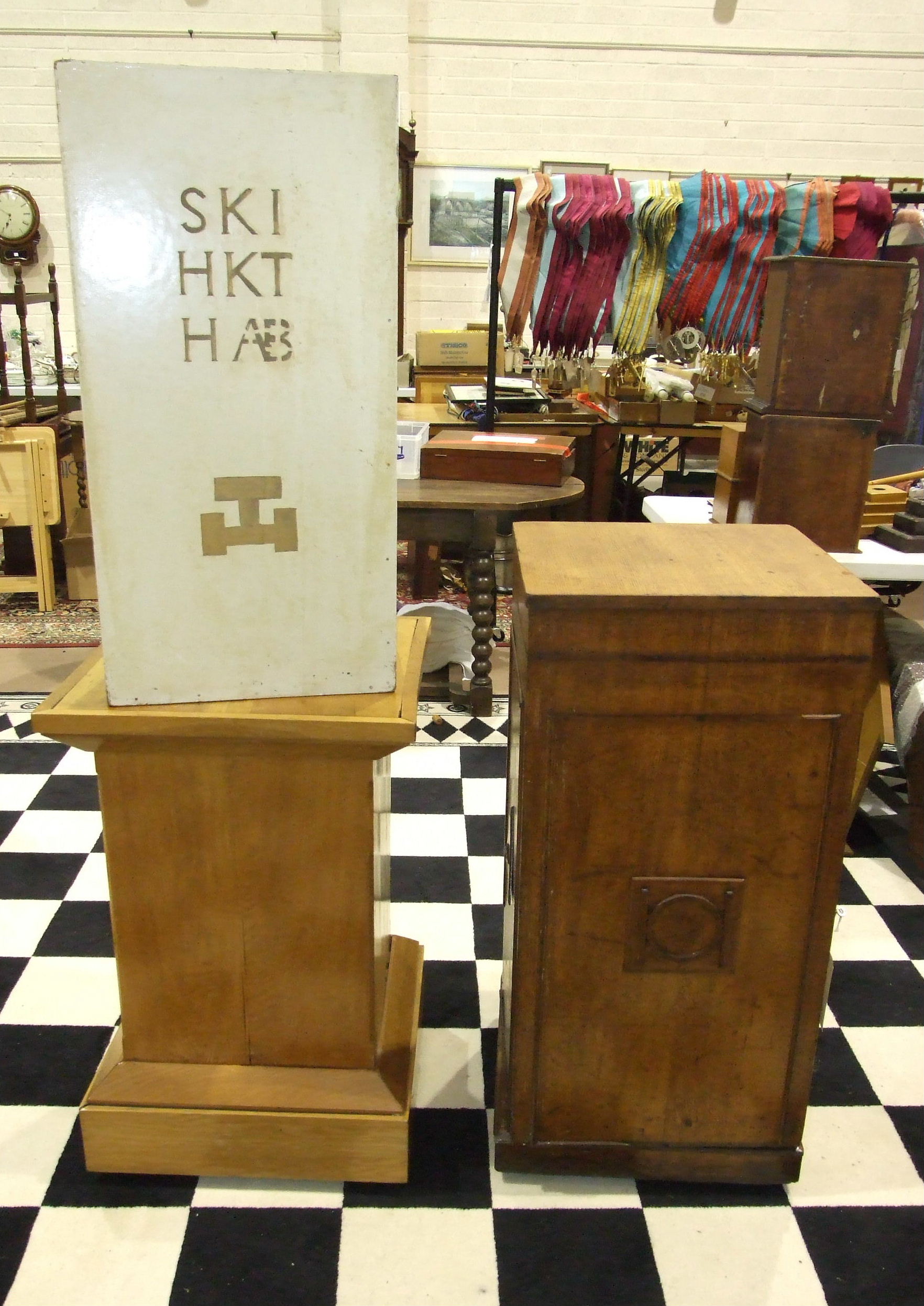 A Masonic oak pedestal with applied wood symbols, on castors, a square-form oak pedestal on