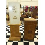 A Masonic oak pedestal with applied wood symbols, on castors, a square-form oak pedestal on