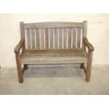 A teak garden bench, 123cm wide.