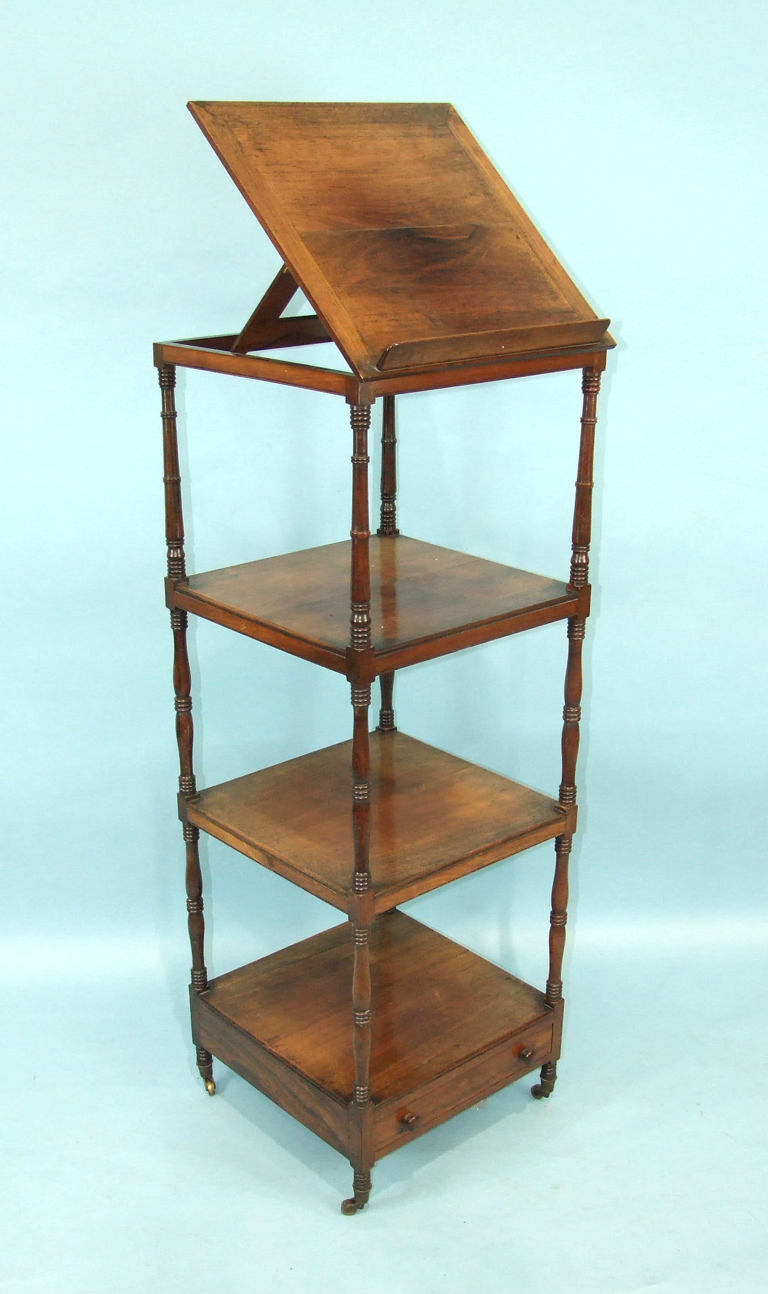 A George IV rosewood four-tier whatnot and music stand, with hinged upper tier above three shelves