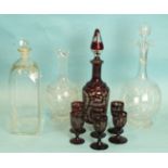 A 19th century red overlay glass liqueur set, (wrong stopper) and three glass decanters with