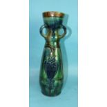 An art pottery three-handled vase of slightly-baluster form, decorated with blue owls on a blue/