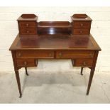 An early-20th century inlaid and cross-banded mahogany lady's writing desk, the top with four