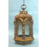 A Victorian bronze lantern of hexagonal pagoda form, the tiled roof above six glazed pierced arch