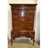 An antique oak chest on stand, the dentil cornice with narrow cushion drawer above three short and