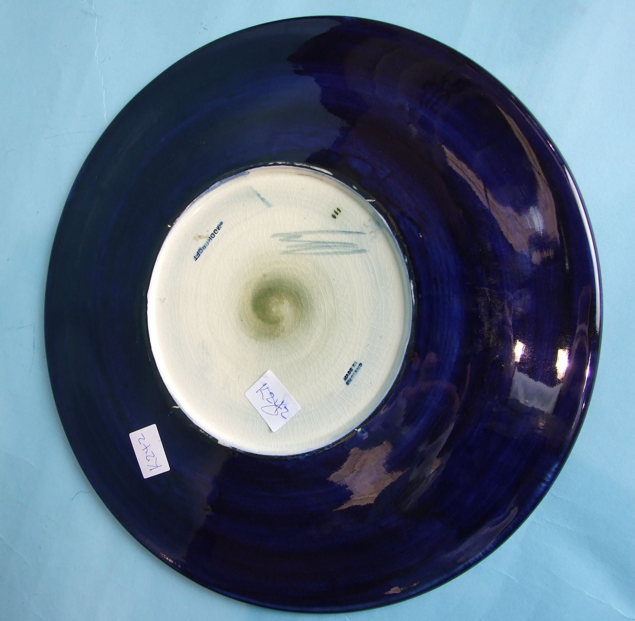 A Moorcroft circular plate decorated with clematis on a blue ground, with WM initials and - Image 2 of 2