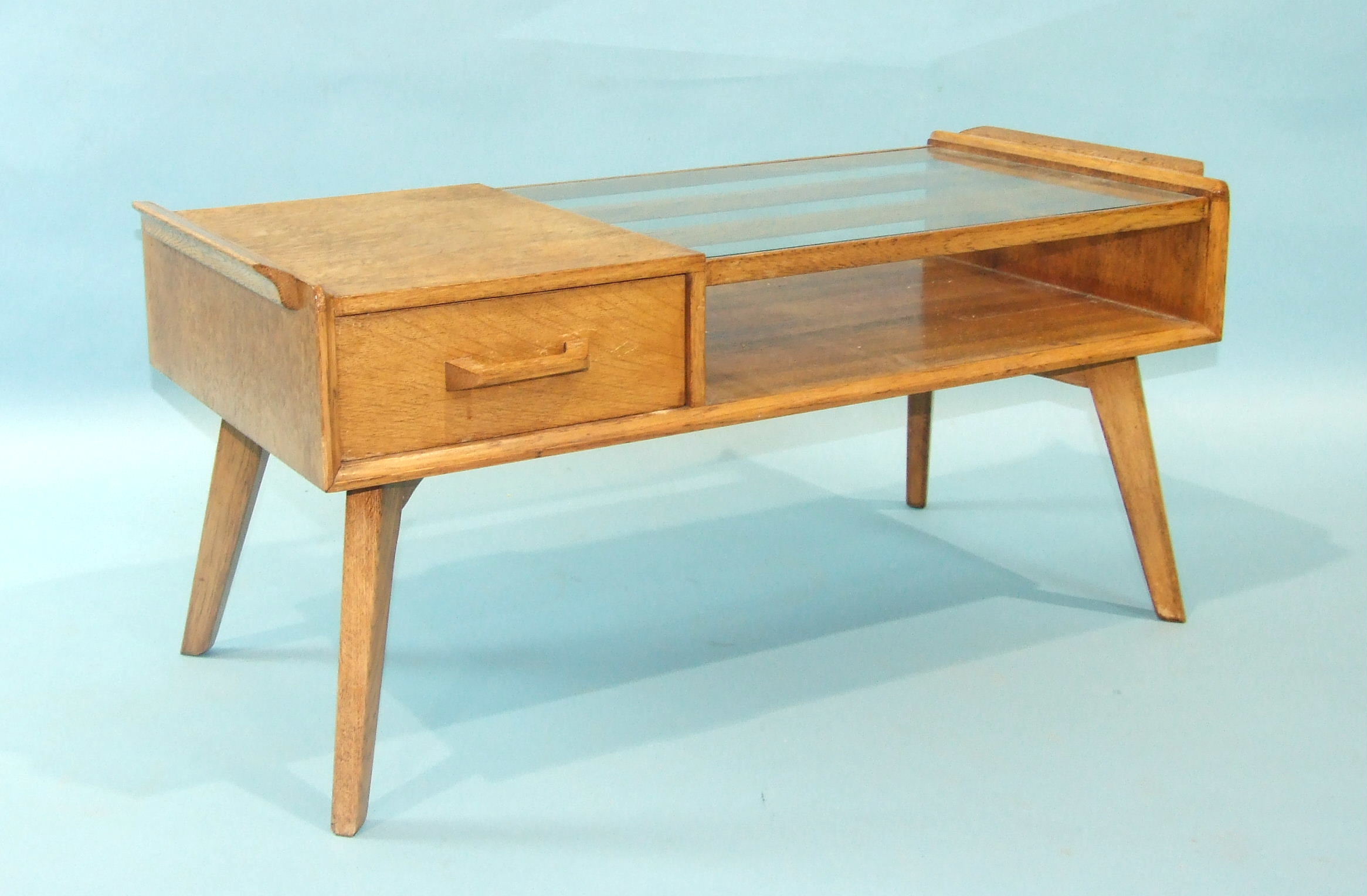 A G-Plan oak low telephone table with partially-glazed top and double-sided drawer, on splayed