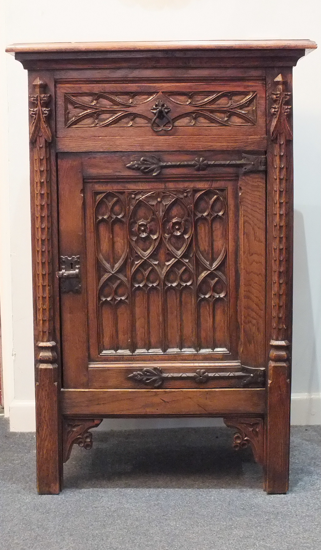 A 20th century French oak Gothic pedestal cupboard of rectangular form, with Gothic carved drawer