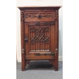 A 20th century French oak Gothic pedestal cupboard of rectangular form, with Gothic carved drawer