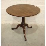 A Georgian mahogany circular tilt-top occasional table with plain stem and tripod support, on pad