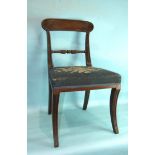 A set of six George IV mahogany sabre-legged dining chairs, each with carved top rail, centre bar
