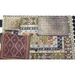 A flat-weave rug of geometric oblong border design, 193 x 129cm, a flat-weave saddle bag, a