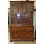 A Late-Georgian mahogany bookcase, the three Gothic reeded astragal-glazed doors above three drawers