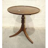 A Georgian mahogany circular tilt-top tripod table, on turned column and plain swept legs, 58cm