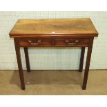 A George III mahogany tea table, the fold-over rectangular top above a pair of frieze drawers, on