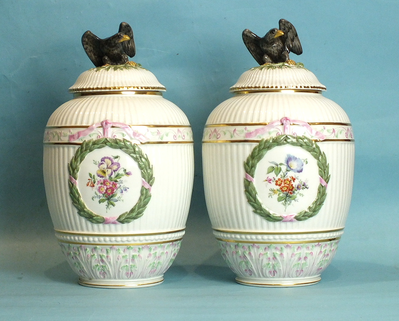 A pair of late-19th century Berlin baluster-shaped vases and covers, each with fluted body painted