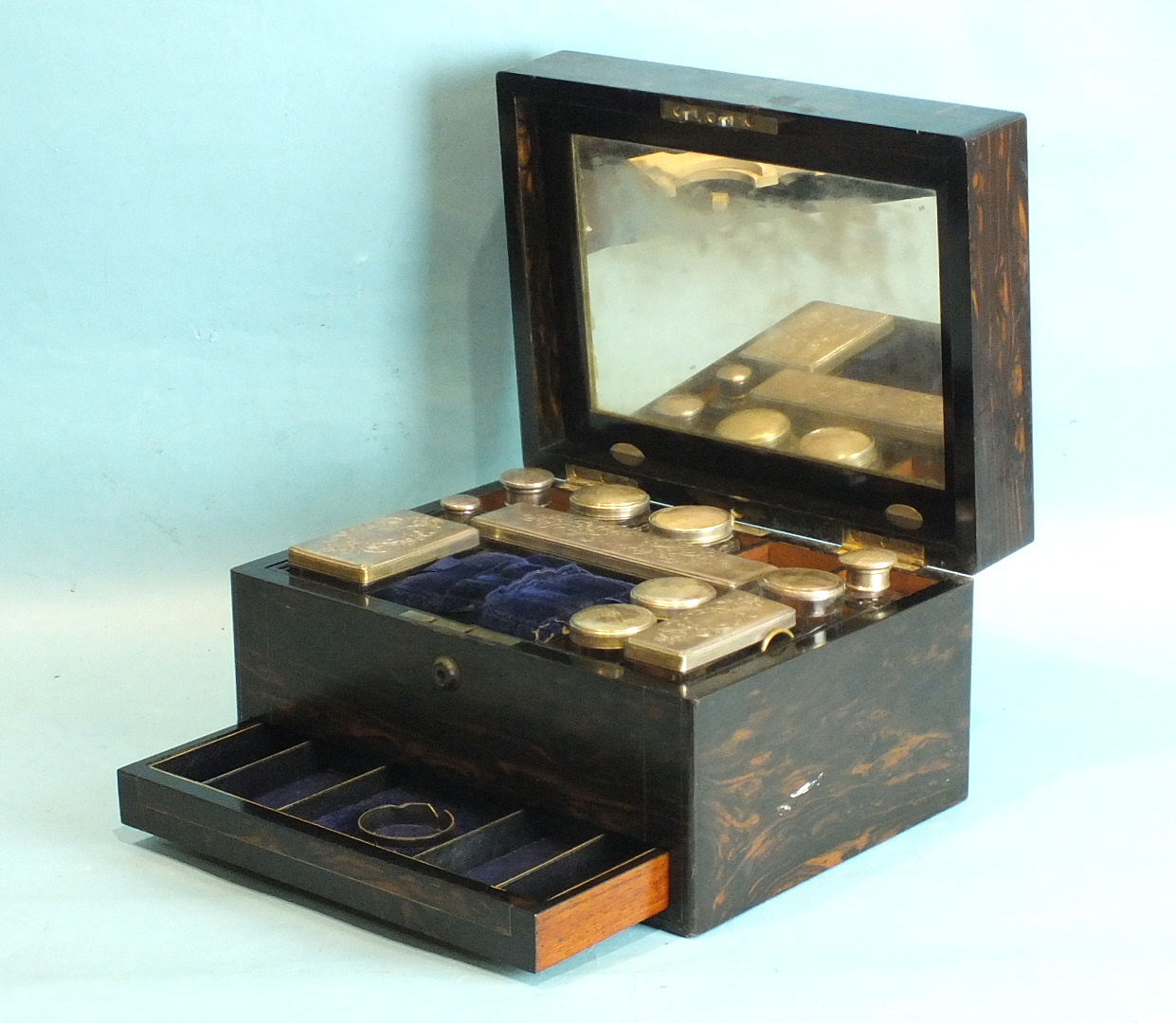 A Victorian ladies coromandel wood dressing case with plate-mounted bottles and concealed