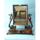 A Victorian mahogany dressing table mirror, the rectangular plate supported by carved swan