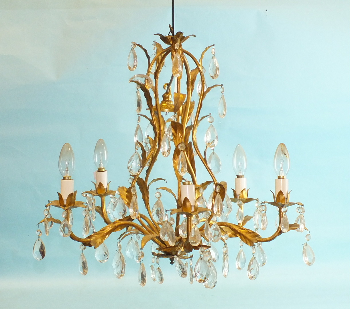 A 20th century gilt metal and cut-glass chandelier of five leafy branches hung with cut-glass drops,