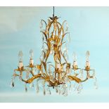 A 20th century gilt metal and cut-glass chandelier of five leafy branches hung with cut-glass drops,