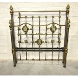 A Victorian 4' 6'' brass and iron bedstead decorated with mirrored mother-of-pearl panels.