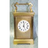 A 19th century French carriage clock, the engine-turned gilt metal face with circular enamel dial