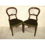 A set of eight Victorian balloon-back mahogany dining chairs with serpentine seats, on fluted turned