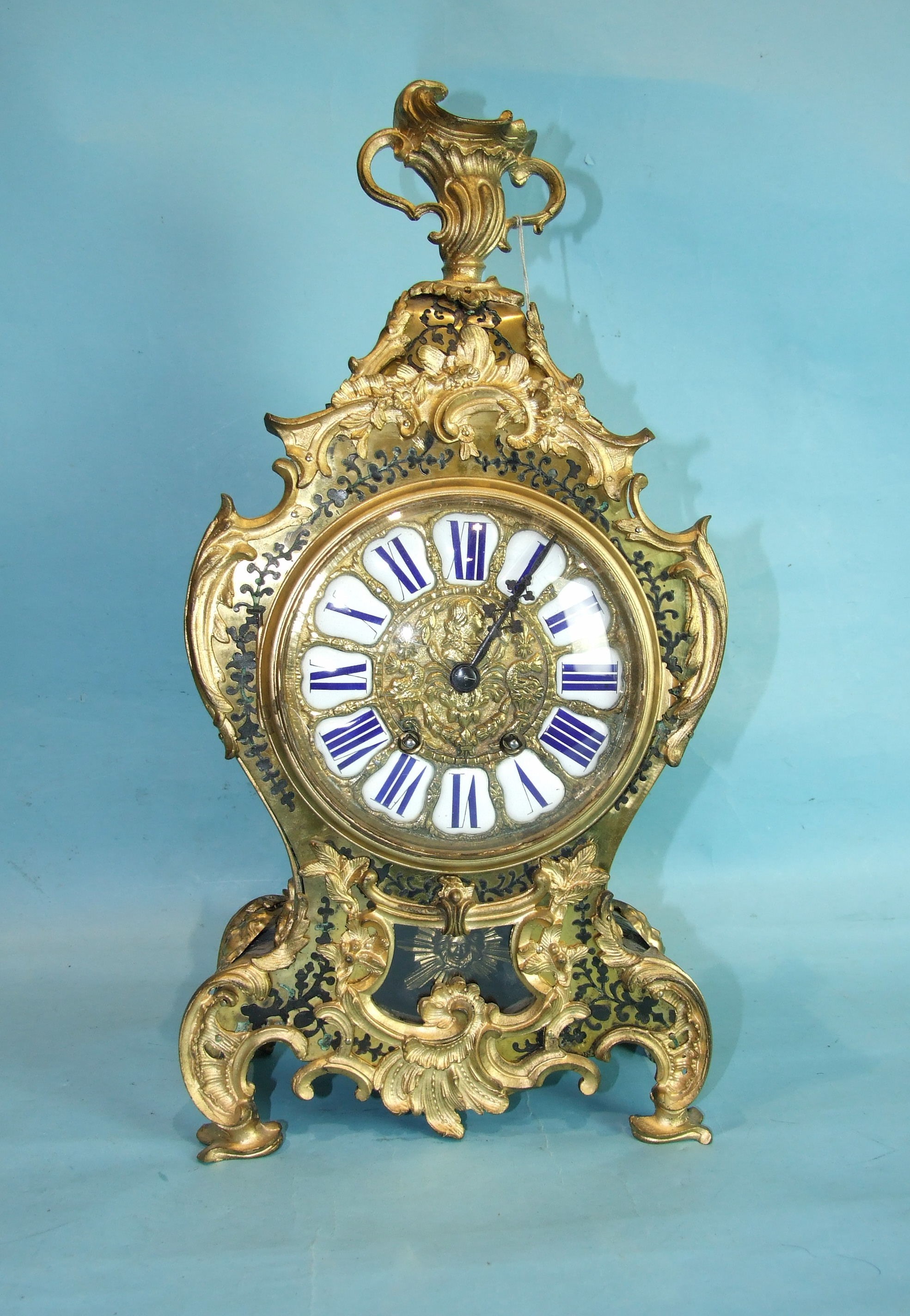 A 19th century French Boulle mantel clock of balloon shape, with gilt metal mounts and twin-train