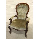 A Victorian walnut salon chair, the carved frame and cabriole legs, with button-back and