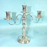 A modern loaded table candelabrum with three sconces and turned stem, 25cm high, London 1972.