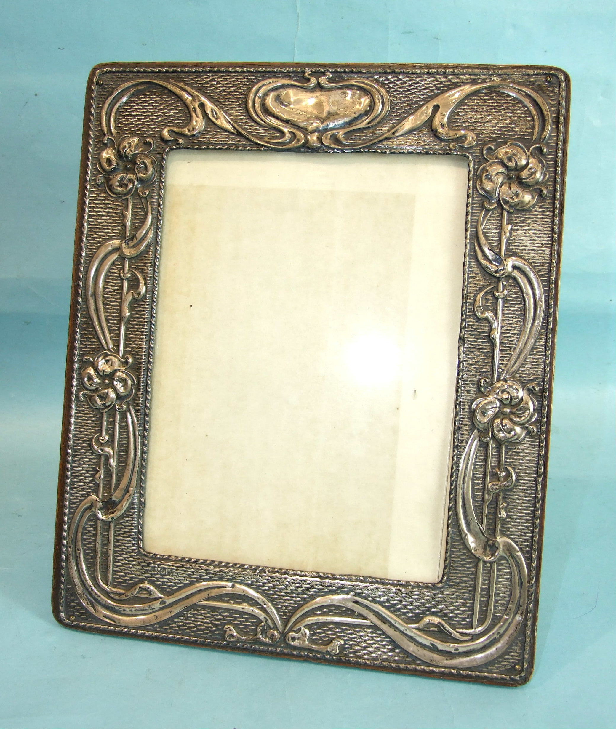 An Art Nouveau embossed photograph frame of rectangular shape, decorated with flowers, Chester 1905,