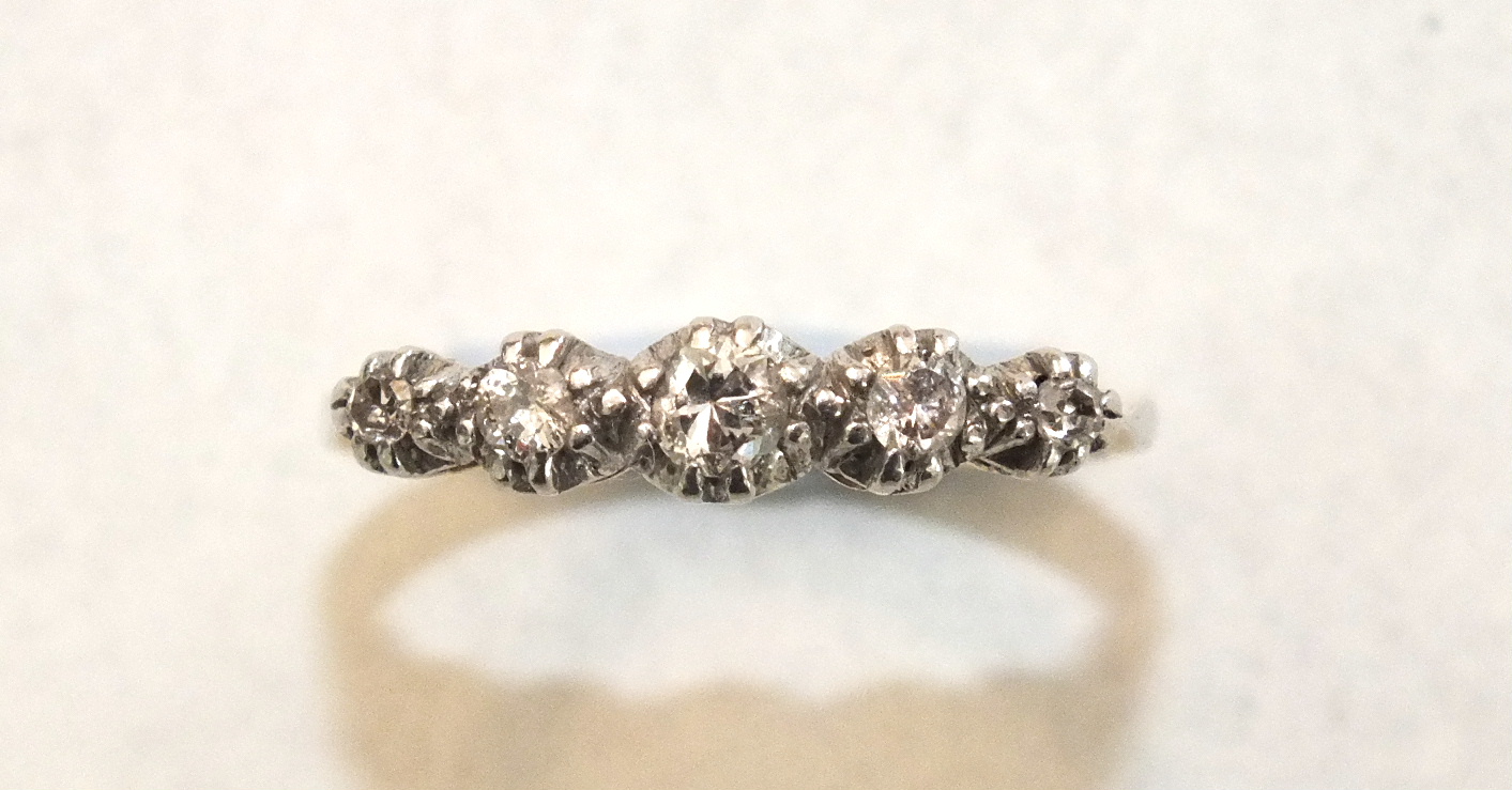 A five-stone diamond ring claw-set graduated brilliant and 8/8-cut diamonds in 18ct yellow gold