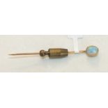 An Edwardian stick pin set an oval opal, in 15ct gold mount.