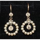 A pair of Edwardian pearl and diamond earrings, each millegrain-set an old brilliant-cut diamond