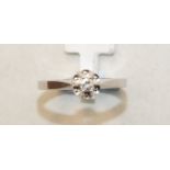 A solitaire diamond ring claw-set a brilliant-cut diamond of approximately 0.1ct, in 18ct white gold