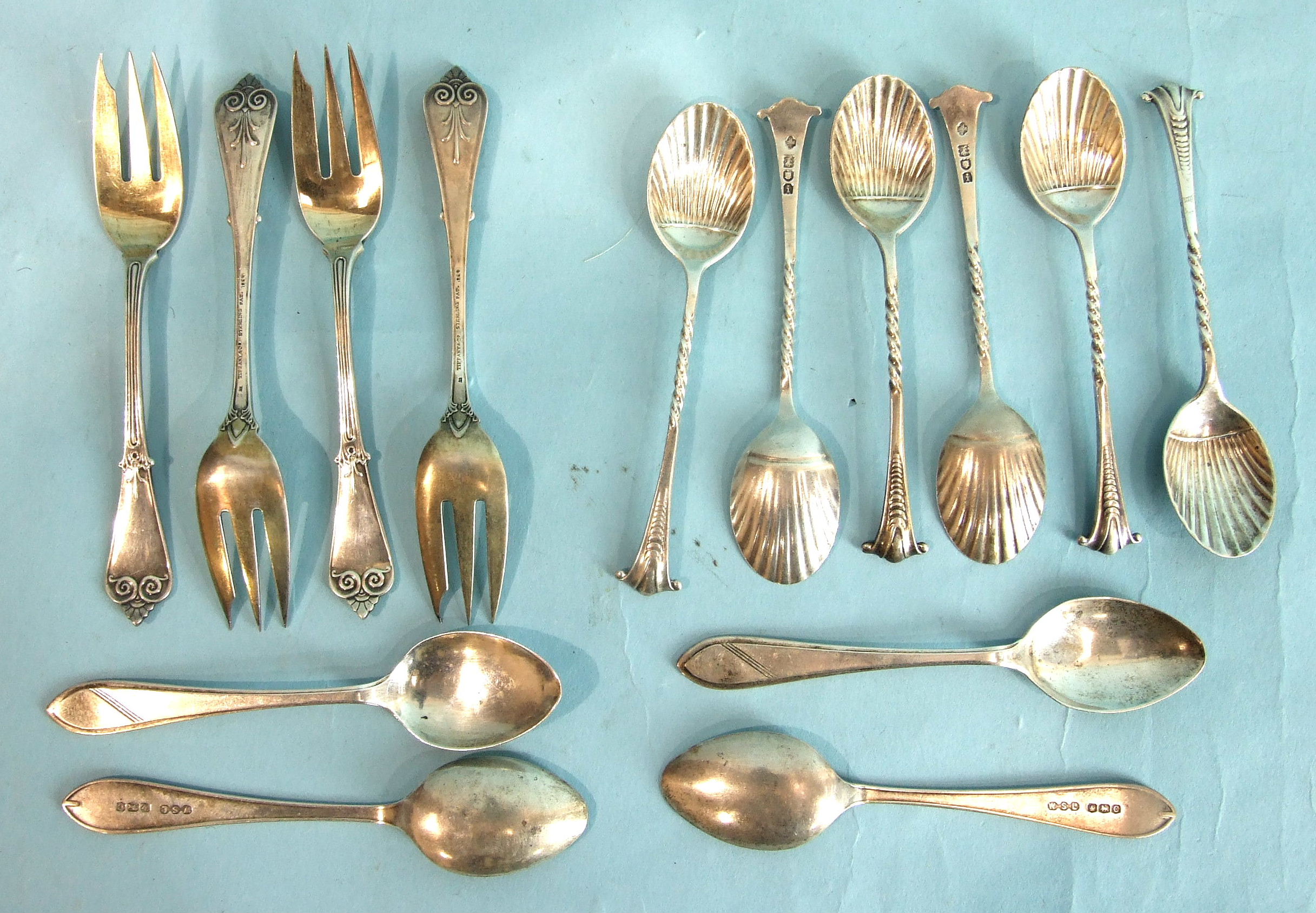 A set of six teaspoons with shell bowls and twist handles, London 1904, four other teaspoons and