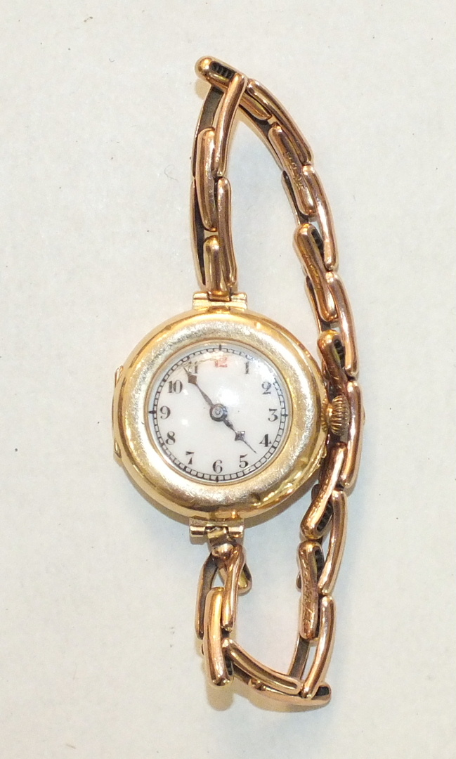 A ladies 15ct-gold-cased wrist watch on 9ct gold sprung bracelet, gross weight 20.5g.