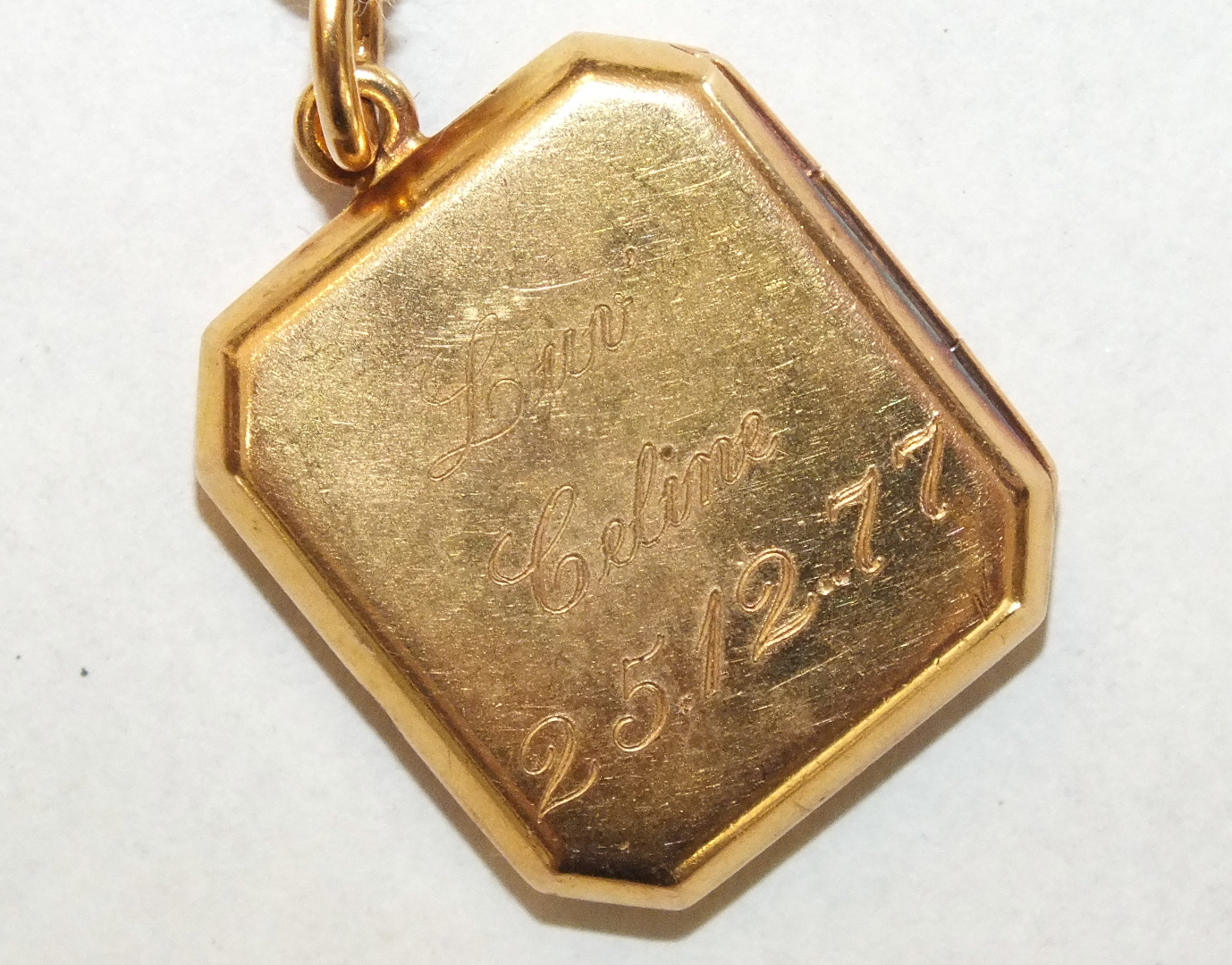 An octagonal 22ct gold locket with engraved inscription, 2.1 x 1.8cm, 7.6g. - Image 2 of 2