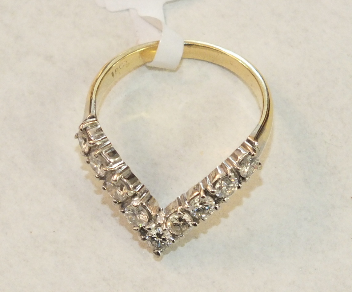 An 18ct yellow and white gold wish-bone ring claw-set nine brilliant-cut diamonds, size P, 4g.