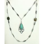 An Arts and Crafts silver pendant on chain set teardrop turquoise cabochon in pierced silver