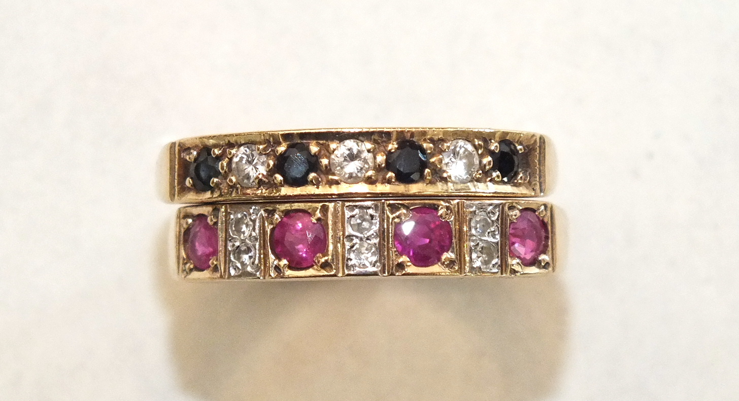 A ruby and diamond 9ct gold half-hoop ring, size Q½ and a similar sapphire and diamond ring, size