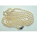 A long necklace of graduated cultured pearls, 6.5mm to 9.5mm, with 18ct white gold clasp set an oval