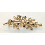 A sapphire and pearl spray brooch claw-set seven round-cut sapphires, amongst demi-pearl-set leaves,